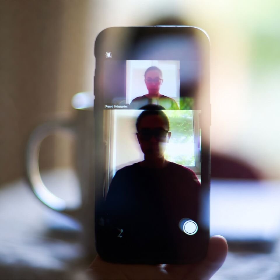 Shaky phone view of virtual lecture with coffee reflection