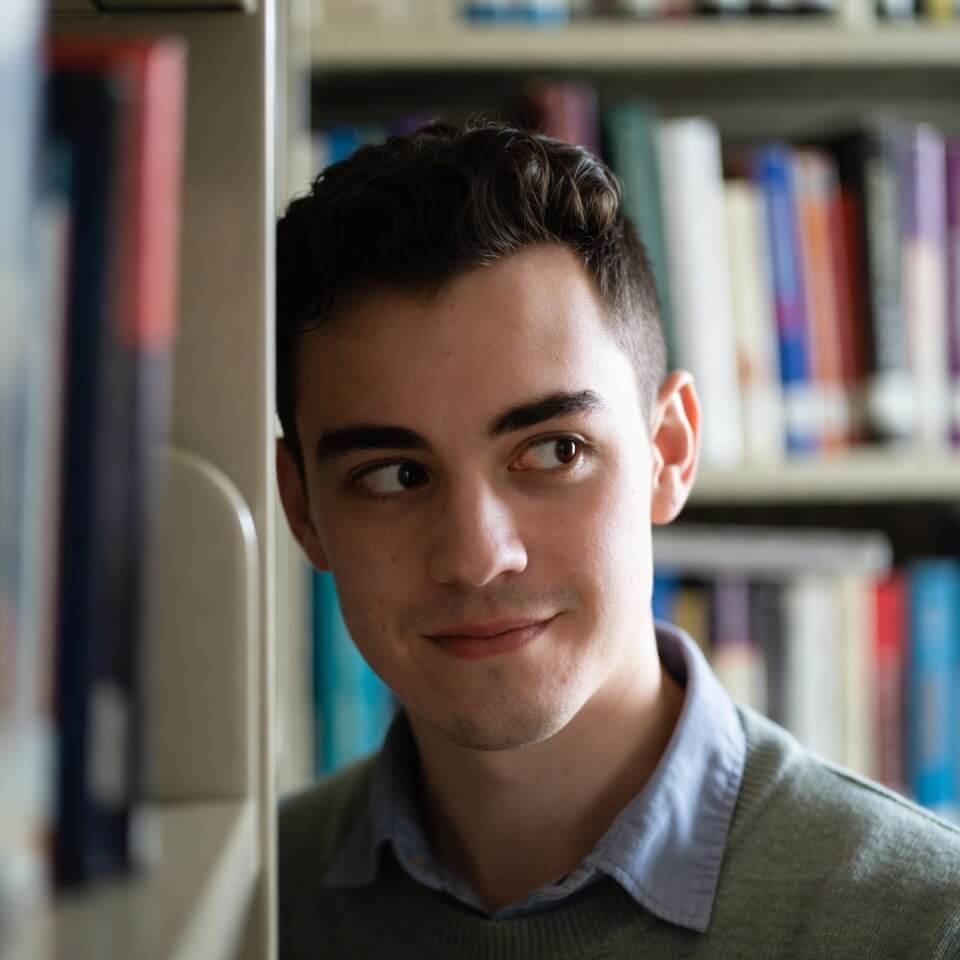 Sneaky sideways glance from behind library books